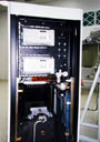 rear of the control console showing the master and slave PLCs, pneumatics, and power distribution